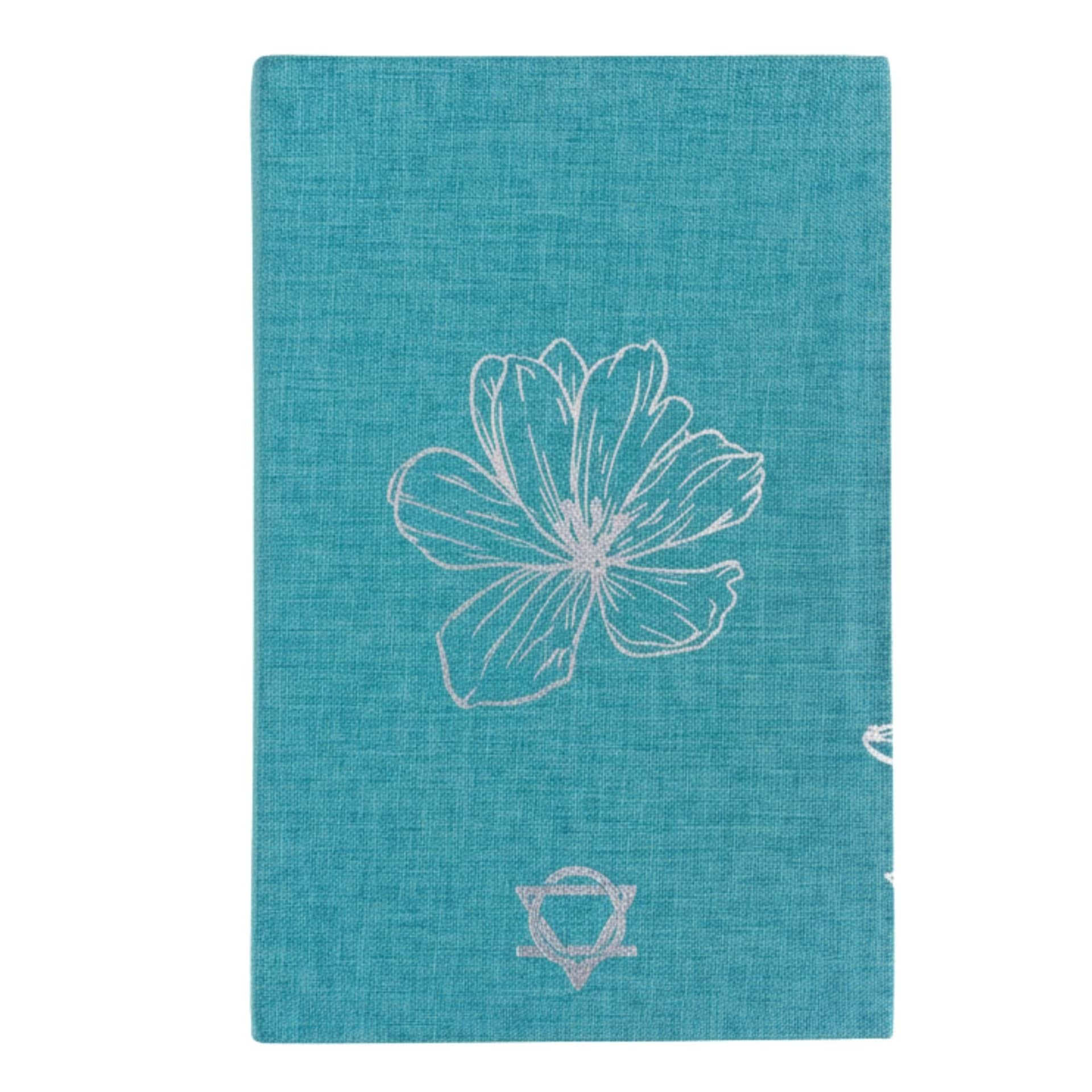 Close-up of the silver eye symbol on the journal cover