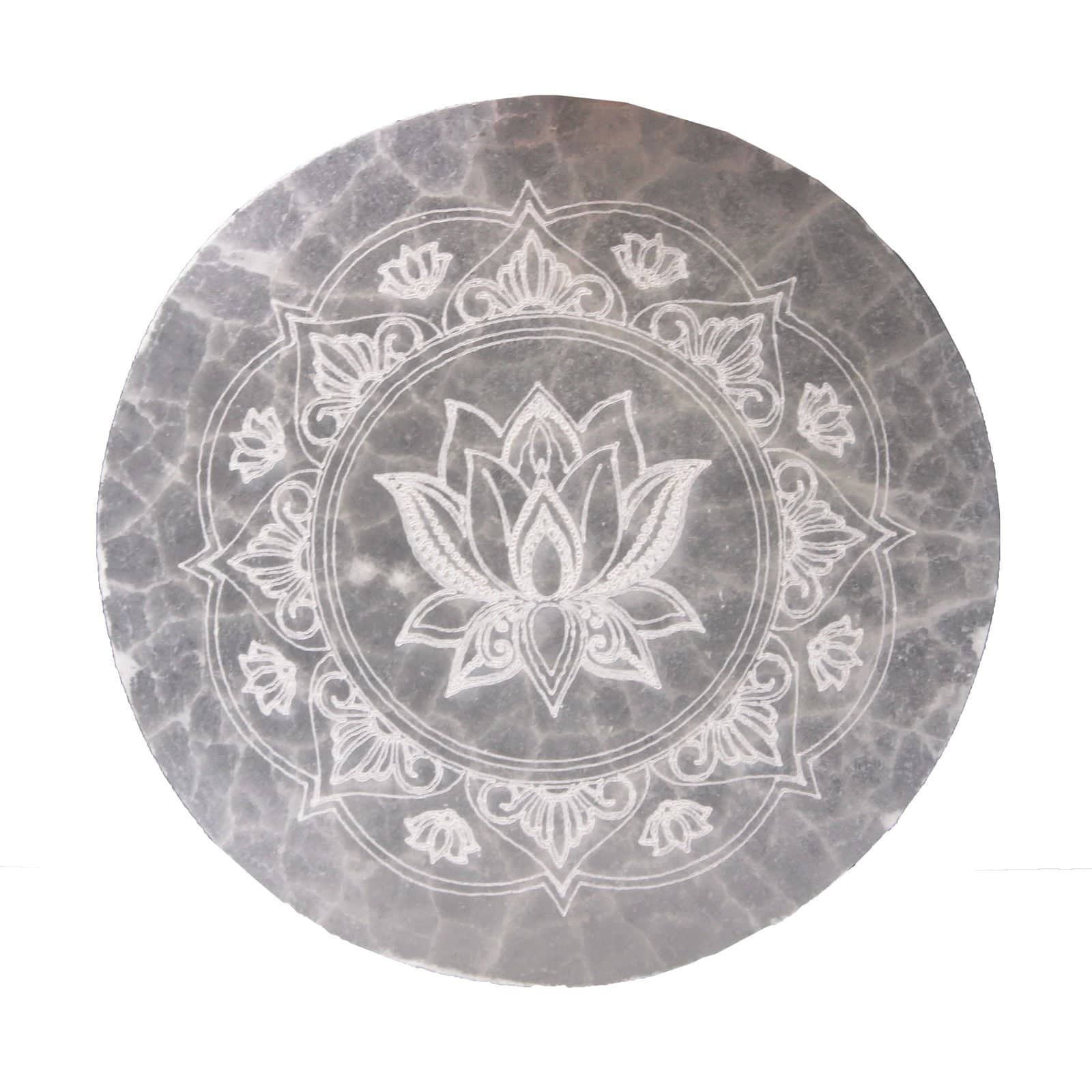 Small selenite plate holding a crystal and a ring