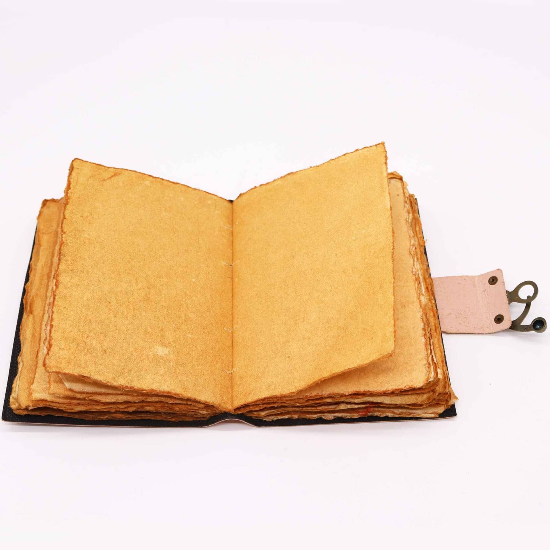 Open leather journal showing rustic deckle-edge pages