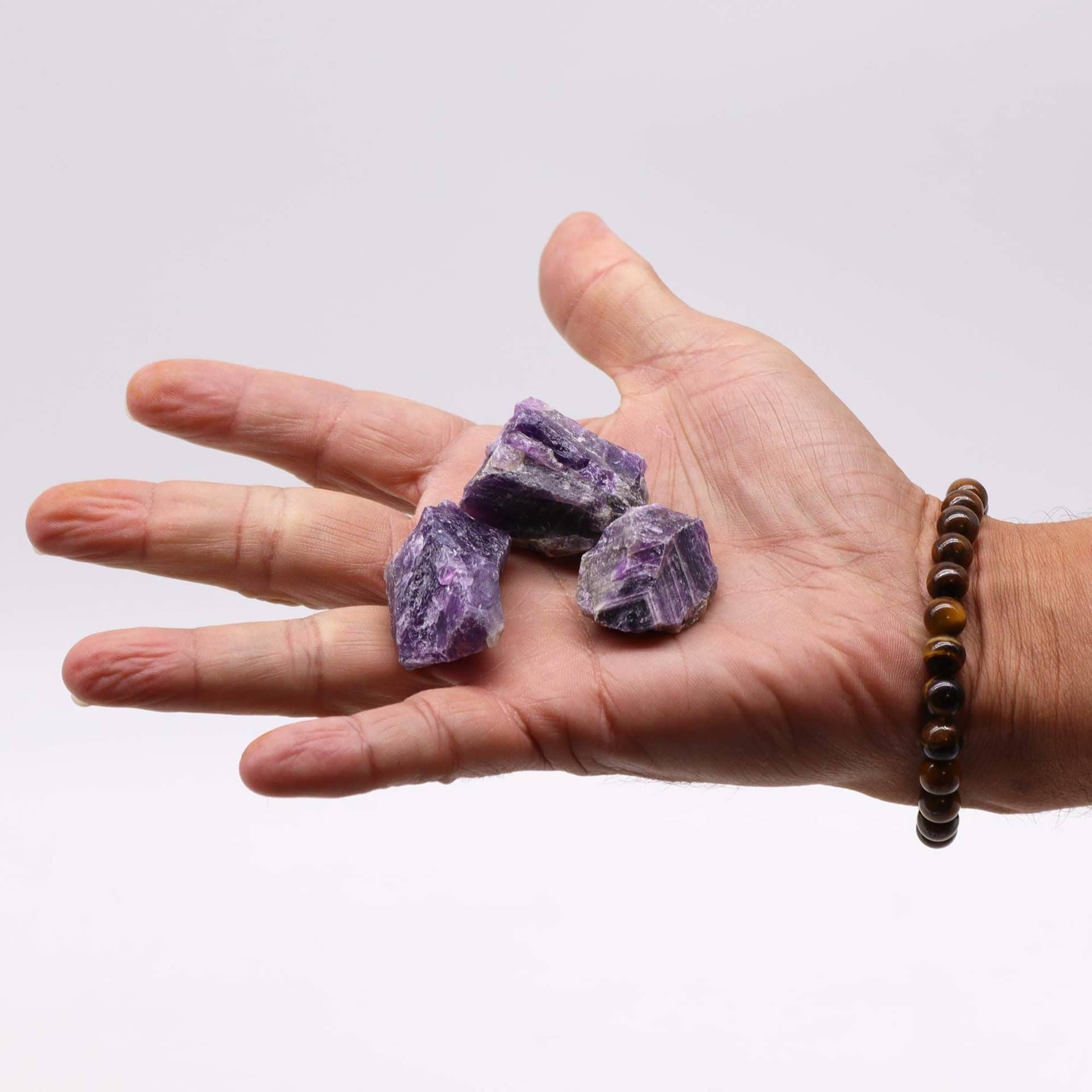 Raw amethyst pieces arranged in a glass bowl