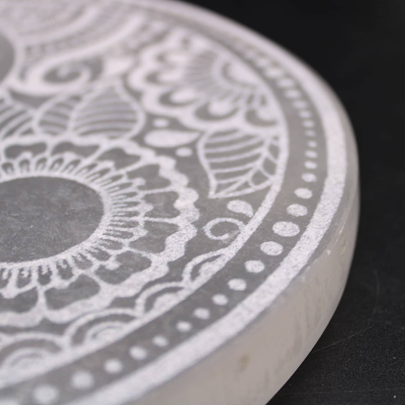 Selenite plate holding a small collection of crystals