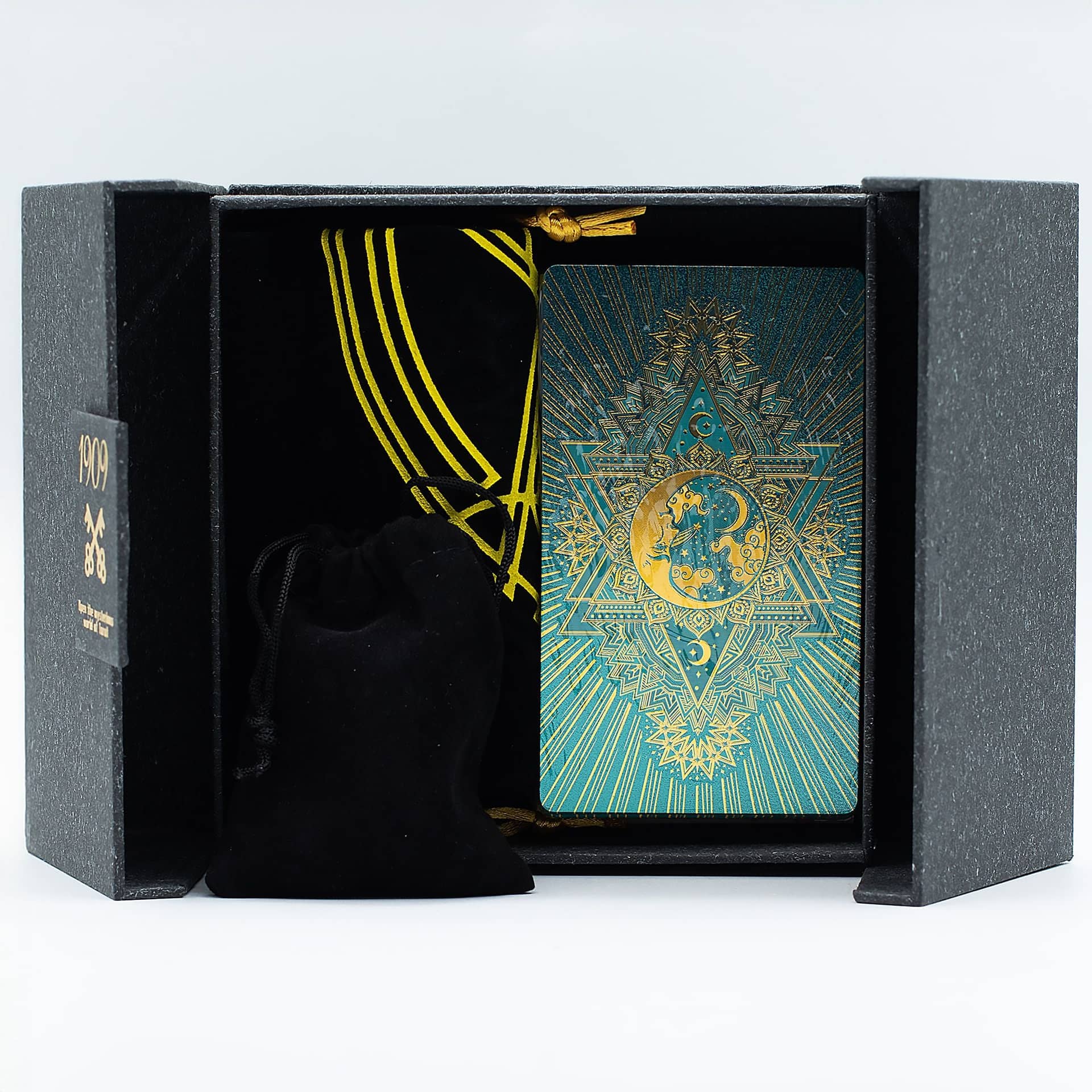 Tarot cards laid out beside the guidebook and open gift box