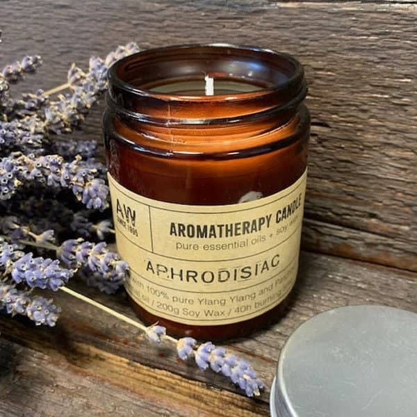 Aphrodisiac aromatherapy candle in an amber glass jar