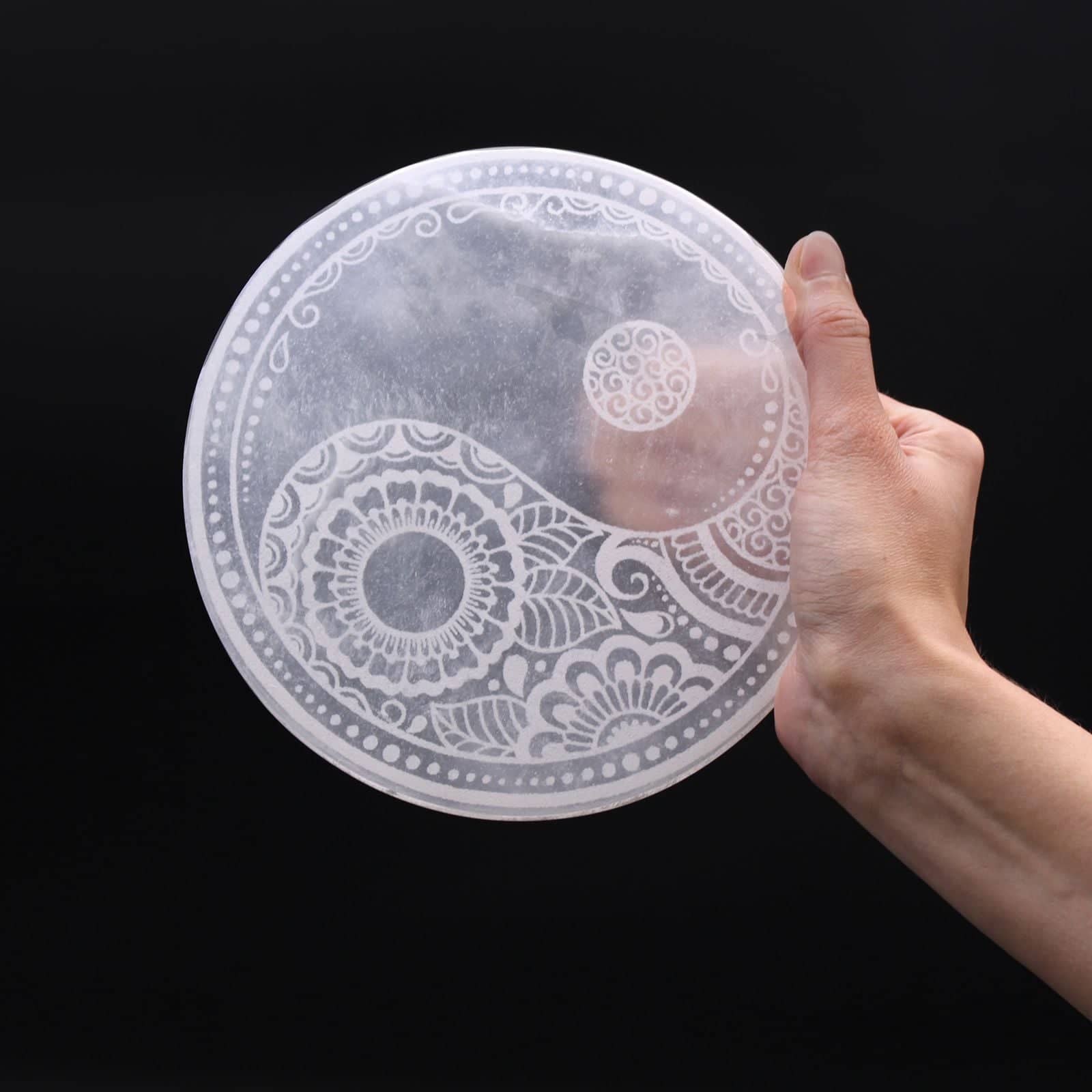 Close-up of the carved design on the white selenite plate