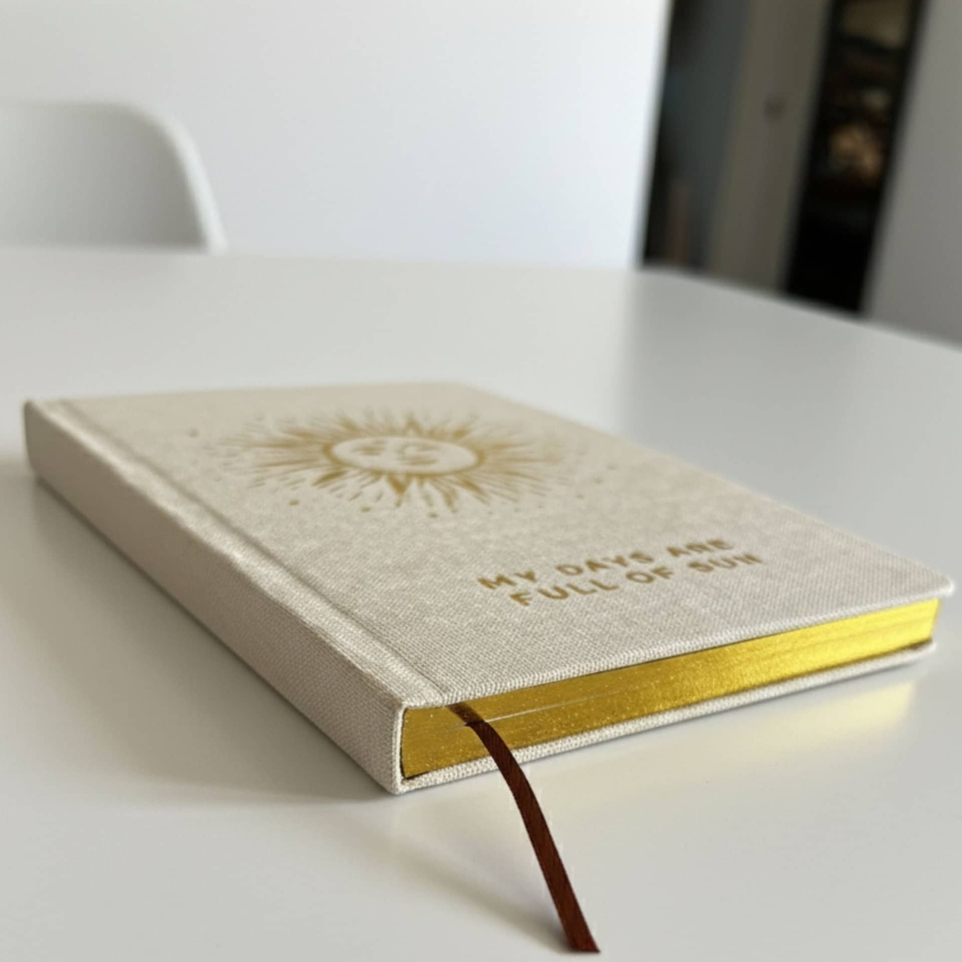 Close-up of the gold page edges and ribbon bookmark