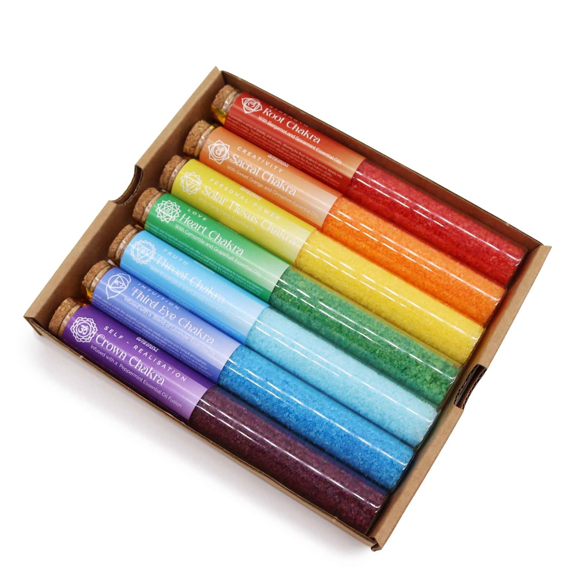 Chakra bath salt vial beside a warm bath