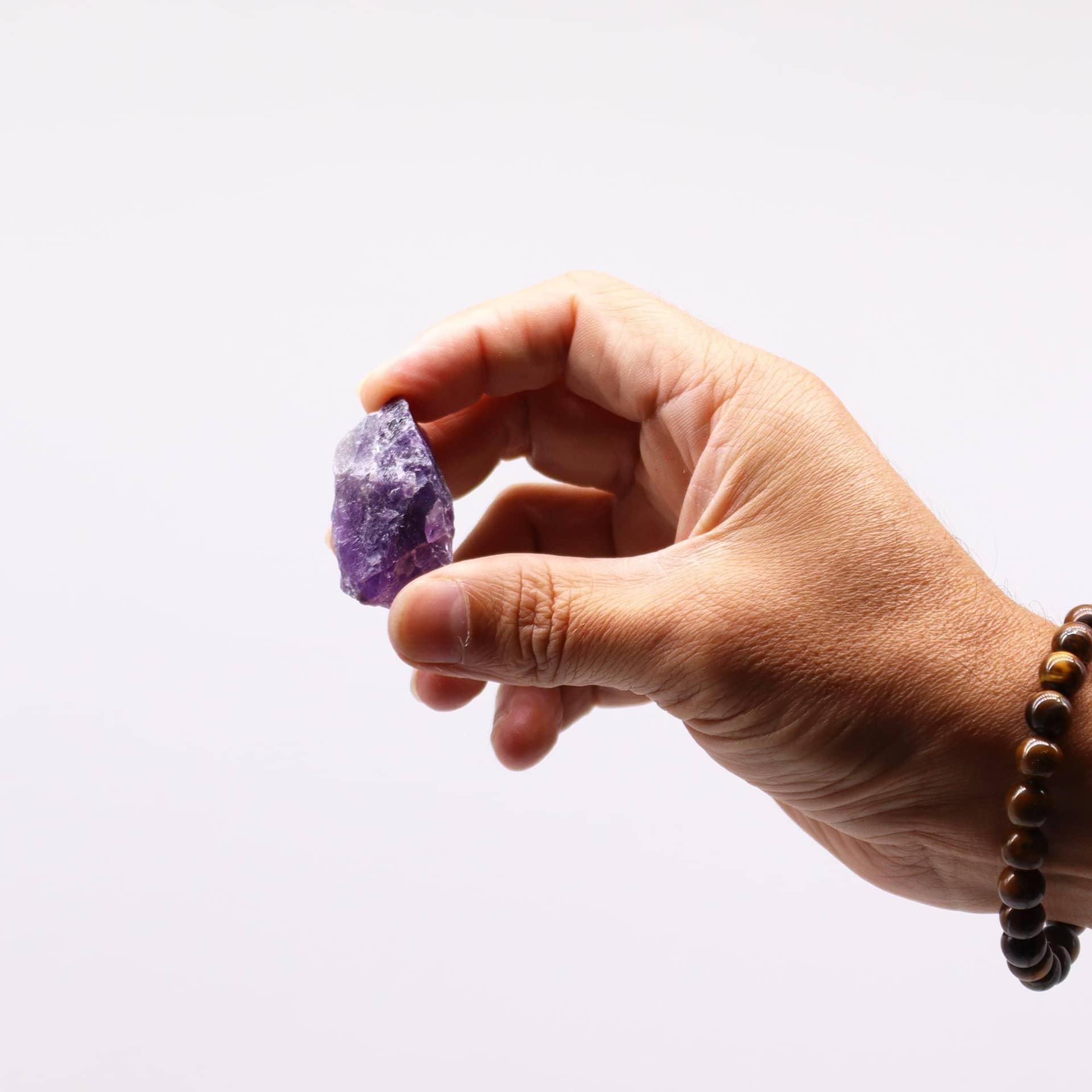 Close-up of the rough texture and purple colour of raw amethyst
