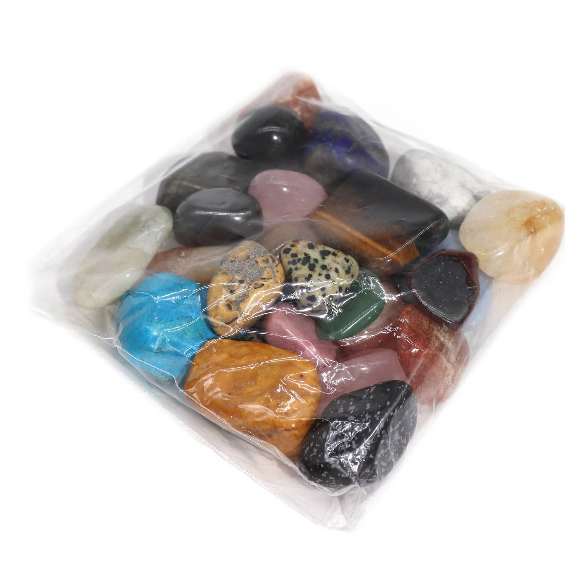 Assorted tumble stones spread out on a table