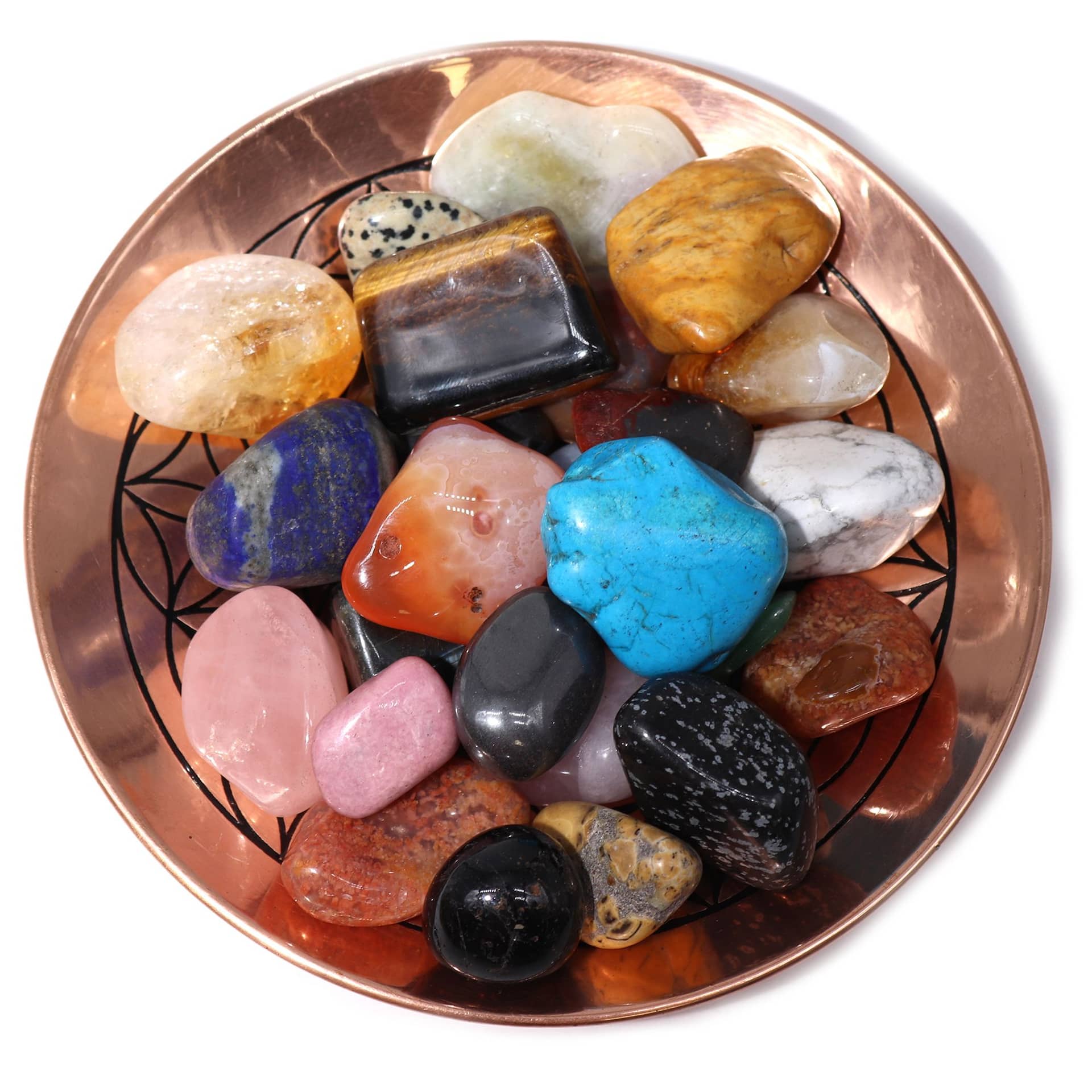 Close-up of polished rose quartz, aventurine and tiger's eye tumble stones