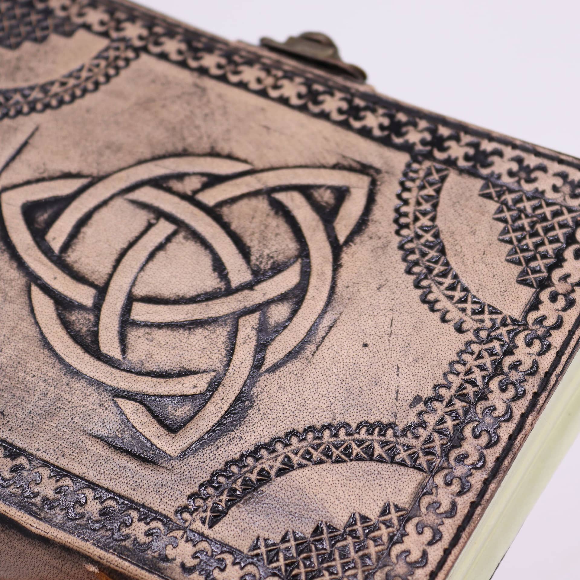 Close-up of the circle triquetra design on the leather cover
