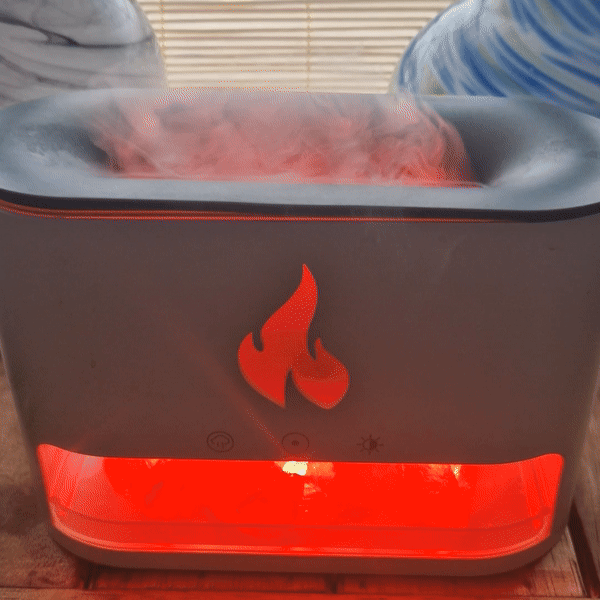 Flame effect diffuser glowing blue on a side table