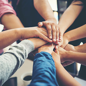 Group of people with their hands one on top of the other