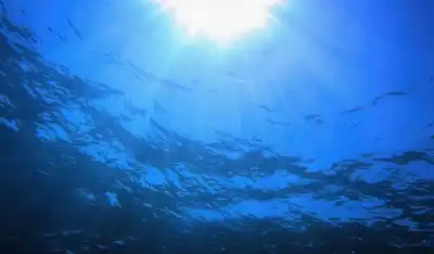 dark sea under water with sun above