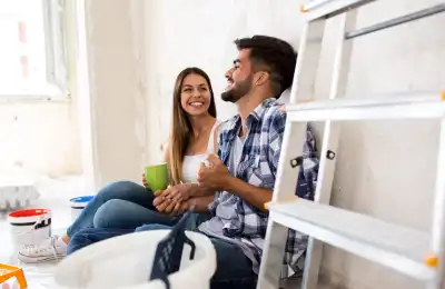 south american couple decorating home