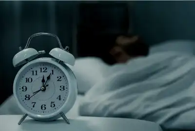 White alarm clock in dark room