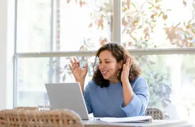 Someone on an online meeting, looking positive.