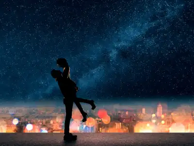 Silhouette of a couple in front of a city skyline and a starry night