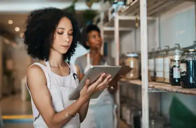 Small business owner holding a tablet.