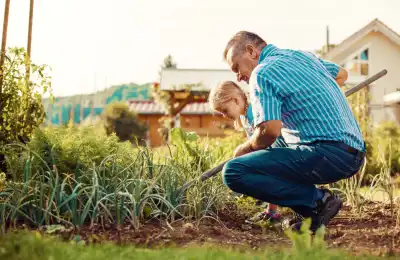 Grandad and granddaughter gardening together