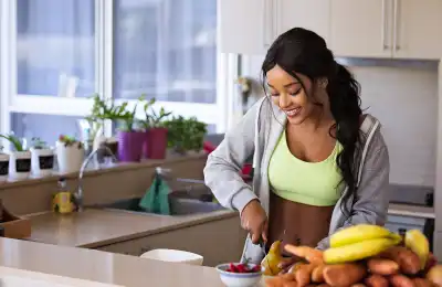 smiling woman cutting up a pear
