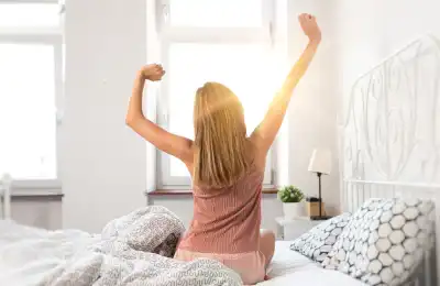 woman stretching in bed after a good night's sleep