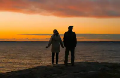couple looking out to the sunrise and ocean