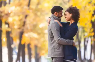 Image of a couple hugging outdoors.