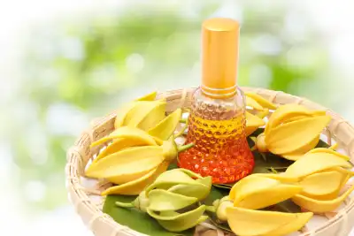 Ylang Ylang on a bamboo tray with a bottle of oil
