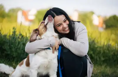 Image of a dog and its owner outside