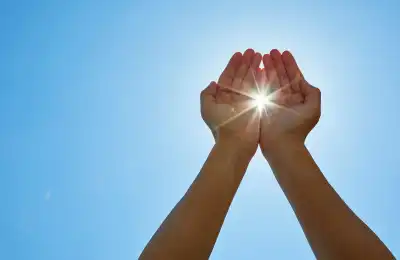 sun shining through hands