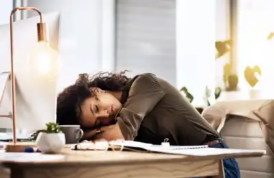 Someone sleeping at their desk.