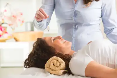 Alternative medicine therapist using a pendulum to make a diagnosis