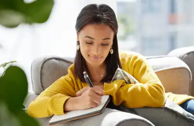 Image of someone writing in a notebook.