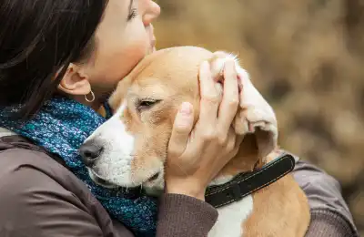 woman hugging dog