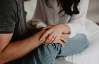 couple holding hands in bed
