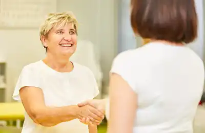 Image of two women shaking hands.