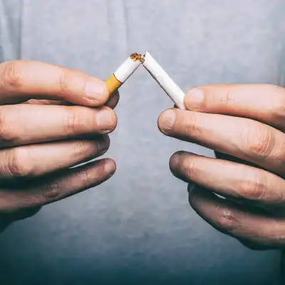 A cigarette being broken in half.