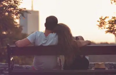 couple sitting on a bench in a city
