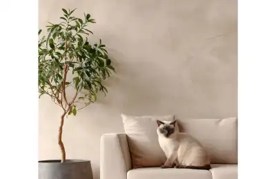 elegant cat sitting next to houseplant
