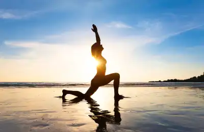woman stretching in front of the ocean