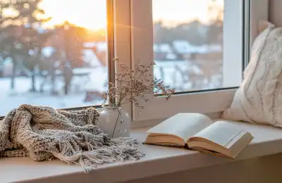 Cosy spot by window with blanket and cushion