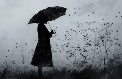 Lady weathering a storm under an umbrella