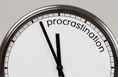 Image of a clock saying 'procrastination.'