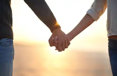 Image of a couple holding hands.