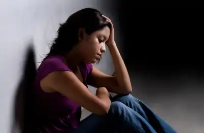 sad woman sitting in dark room