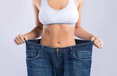 woman wearing large trousers showing weight loss