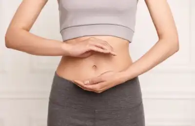 woman holding stomach with both hands