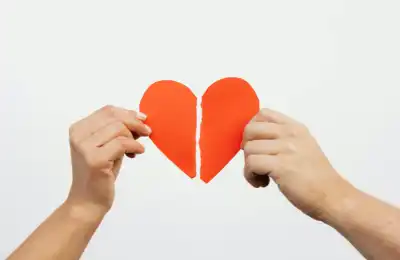 hands holding broken heart