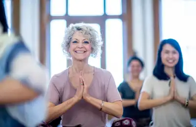 smiling older woman at yoga class