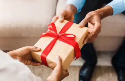 Image of someone giving someone else a gift.